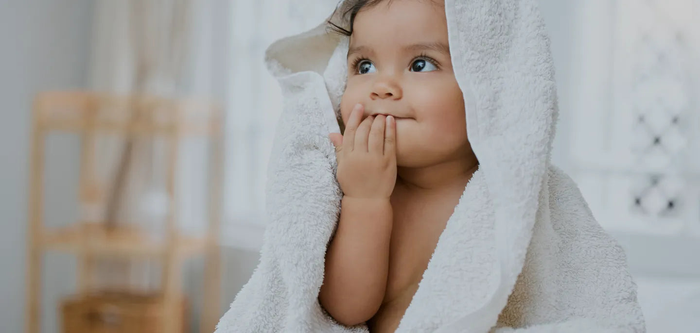 Cute baby with a towel on his head