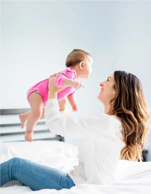 Mom lifting baby