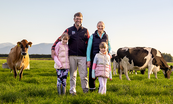Farming family posing in their dairy farm